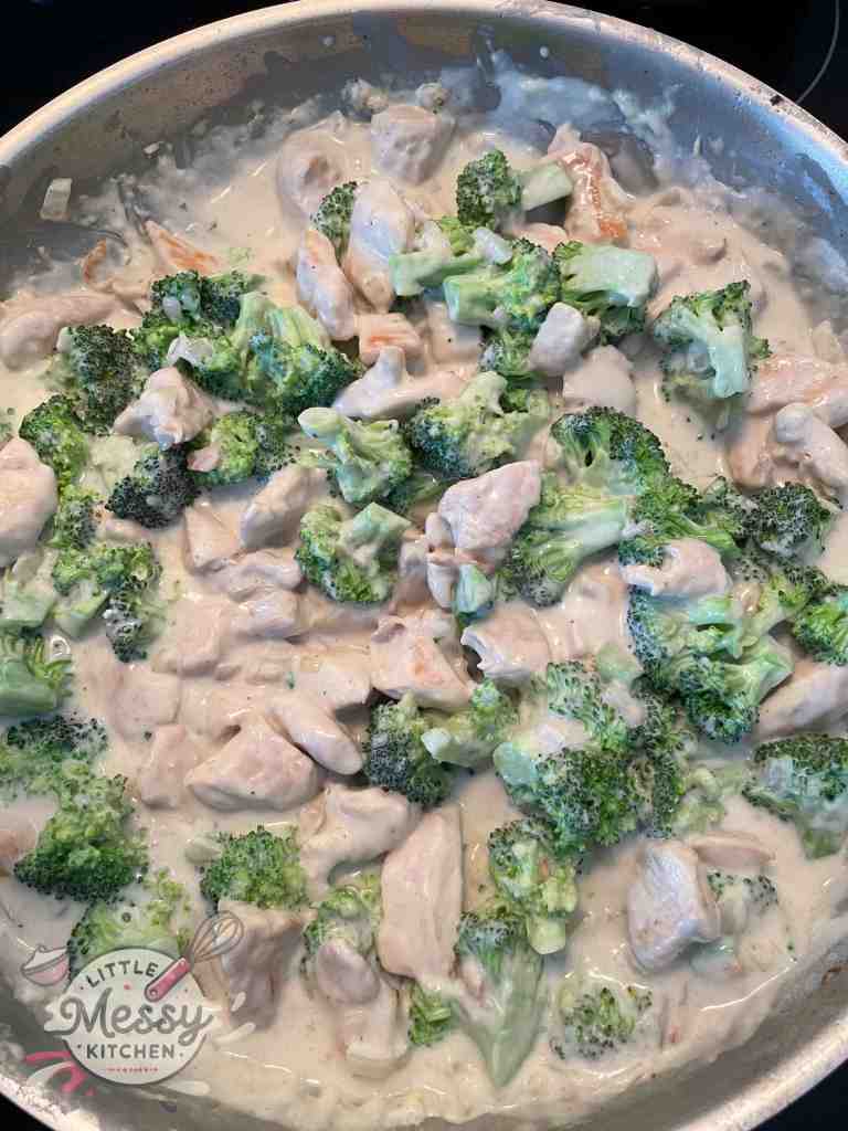 Broccoli and chicken added to the skillet.