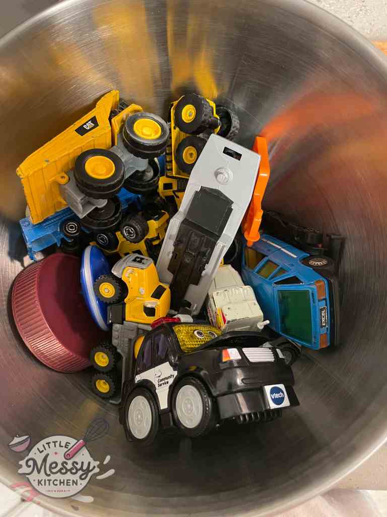 Variety of little cars in a stand mixer.
