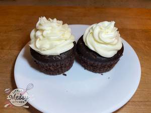 2 chocolate cupcakes served on a plate.