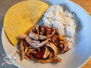 Slow cooker Mexican chicken, served with rice and corn tortillas.