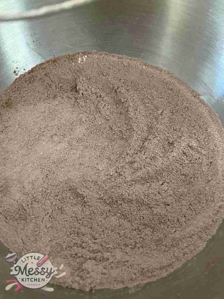 sugar, flour, cocoa powder, baking powder, and baking soda in a mixing bowl.