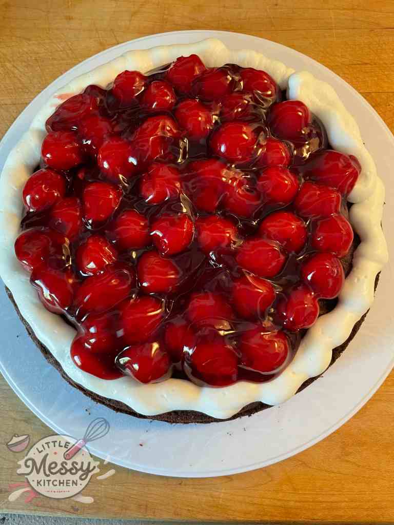 Cherry filling and whipped cream on top of cake layer.