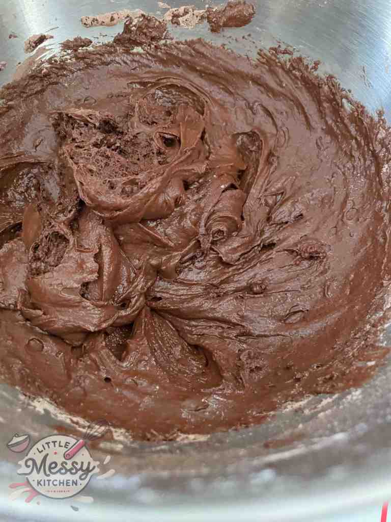 Wet ingredients mixed to the dry ingredients in a mixing bowl.