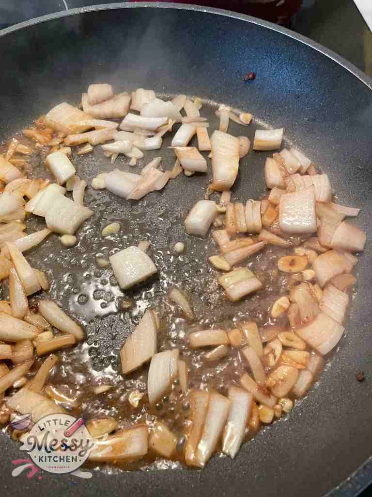 Onions and garlic sauteing in skillet.