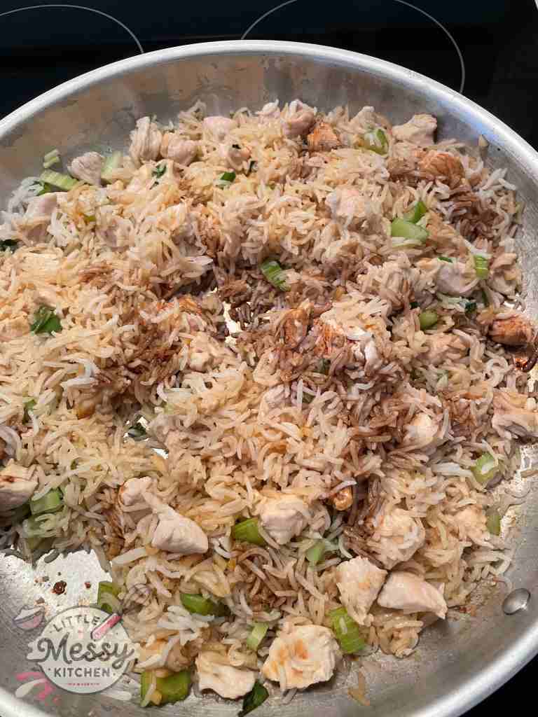 Rice and soy sauce added to the pan.