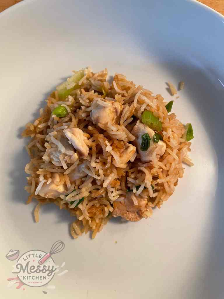 Serving of chicken fried rice in white bowl.