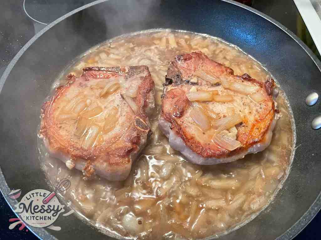 Pork chops cooking in broth