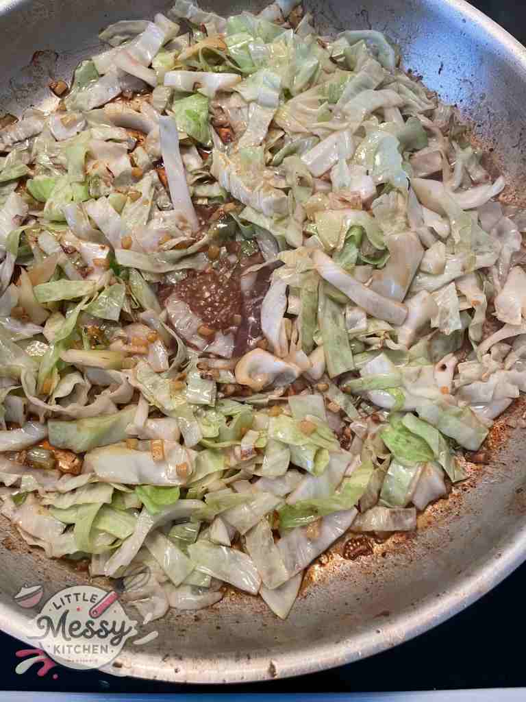 Soy sauce and water added to the frying pan.