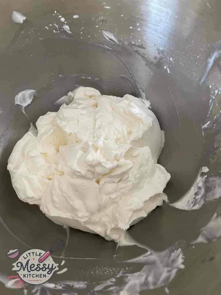 Whipped cream icing in mixing bowl.