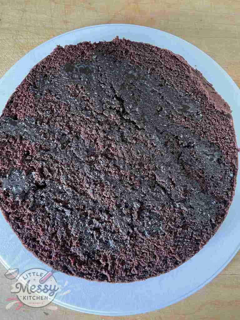 Chocolate syrup spread on top of cake layer.