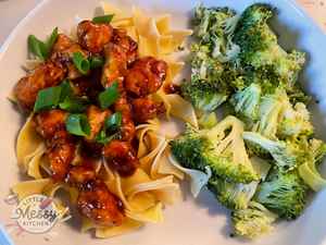 Serving of Sweet and Sticky Sesame Chicken in a white bowl.