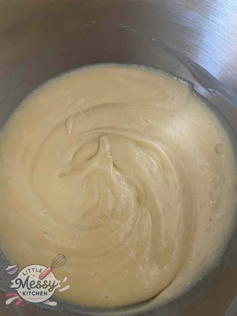 Eggs, milk, melted butter, vanilla extract, and almond extract added to the dry ingredients.