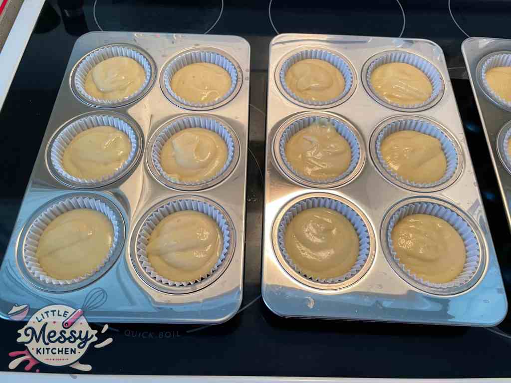 Batter divided in cupcake pans.