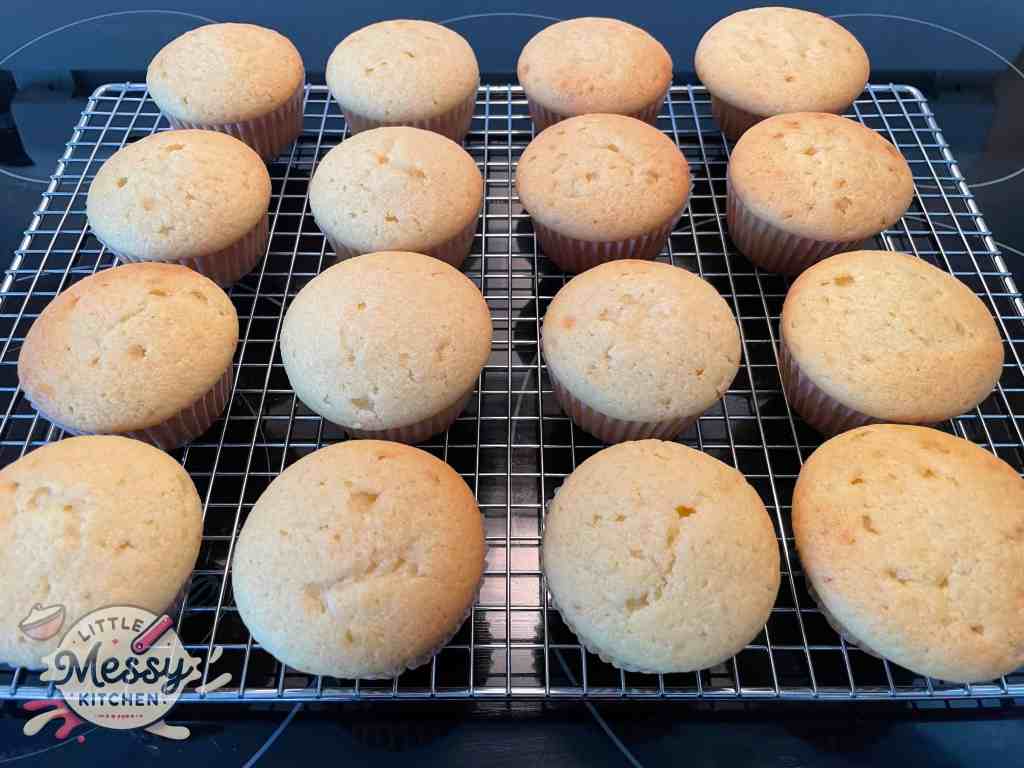 Cooked cupcakes on a cooling rack.