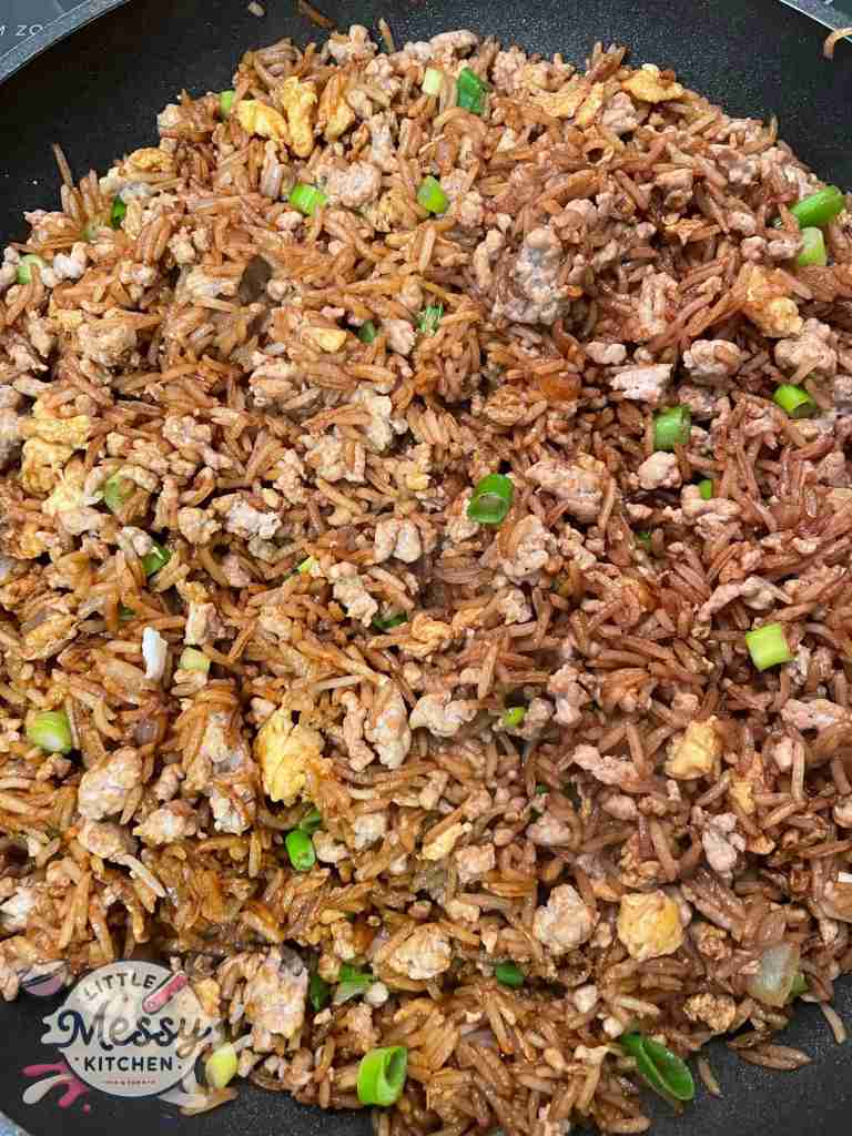 Pork fried rice in a skillet.