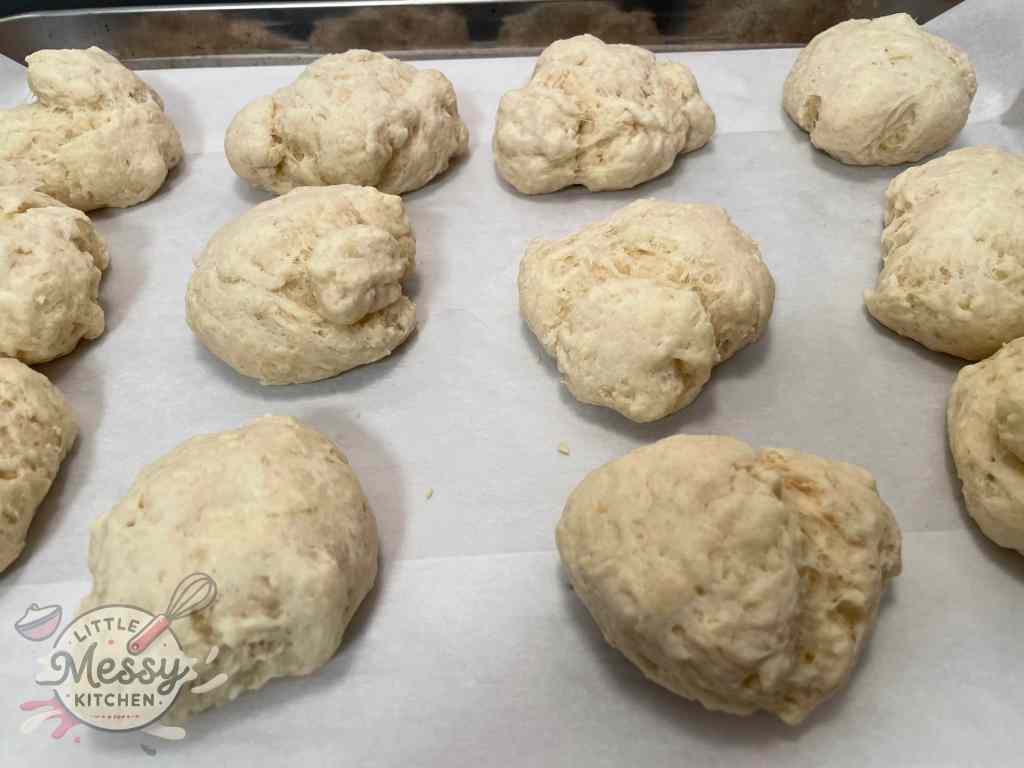 Baked dumplings on a baking sheet.