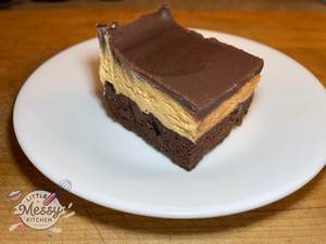 Serving of Triple Layer Buckeye Bars on a white plate.
