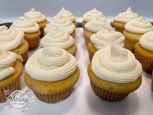 Frosted vanilla cupcakes on a platter.