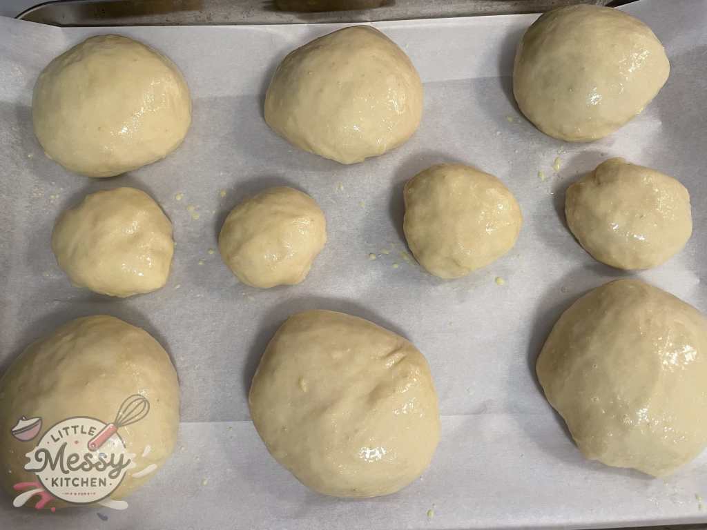 Dough divided on a baking sheet.