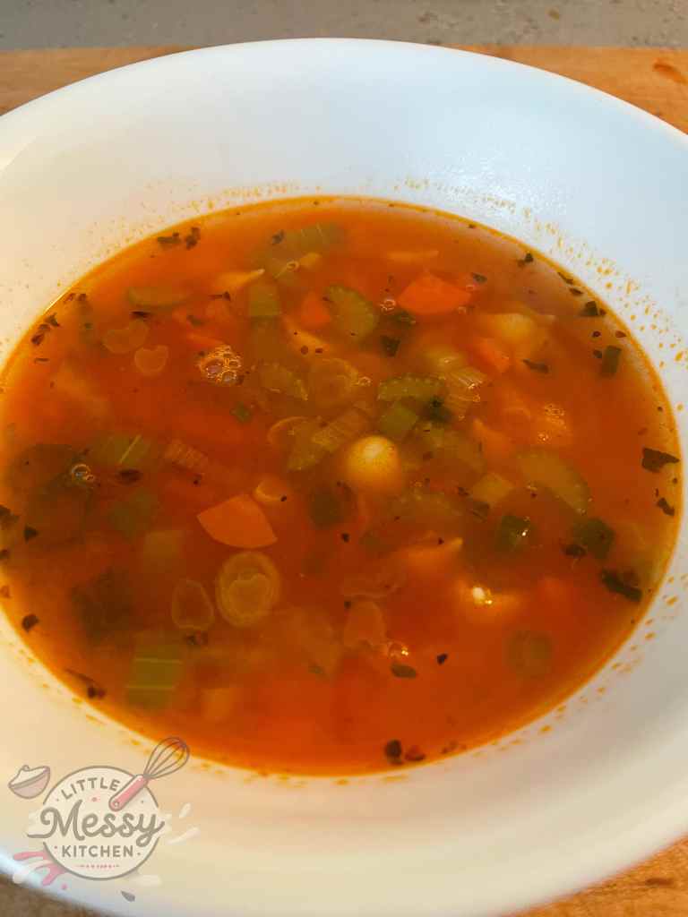 Vegetable soup served in a white bowl.