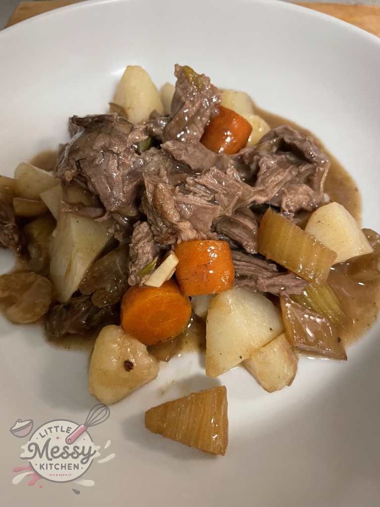 Serving of pot roast in a white bowl.