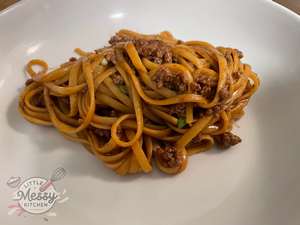 Serving of Mongolian-style Beef Noodle in a white bowl.