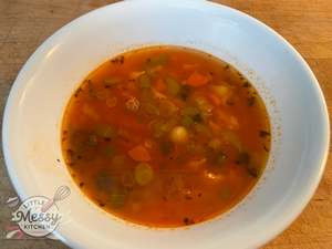 Vegetable soup served in a white bowl.