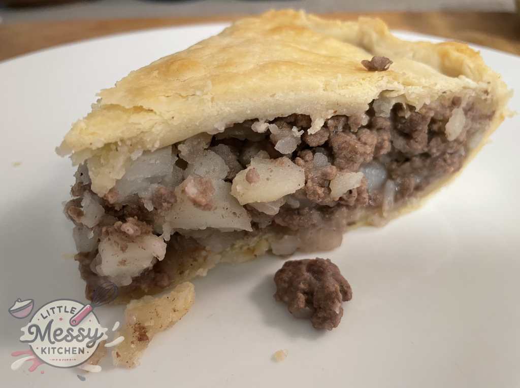 Slice of French Canadian Tourtière served in a plate.