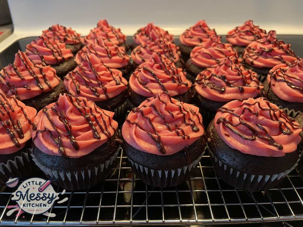 Decadent Raspberry-Filled Cupcakes on a cooling rack