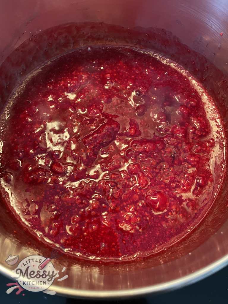 Raspberry filling in a saucepan.