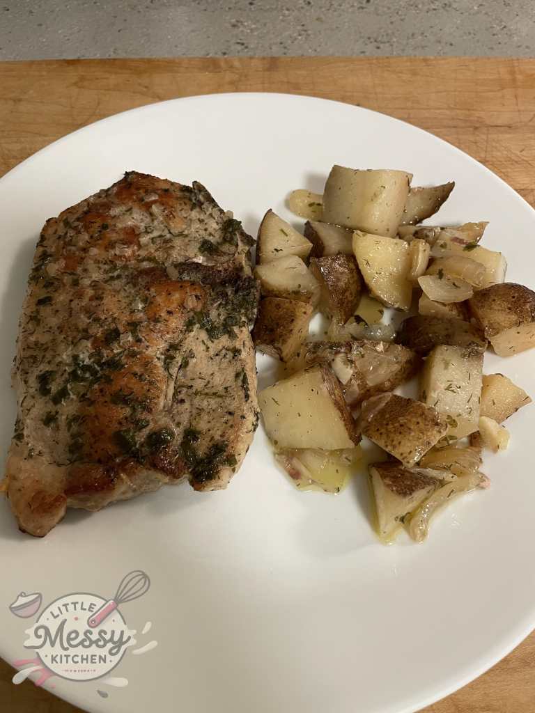 Serving of ranch pork chops and potatoes.