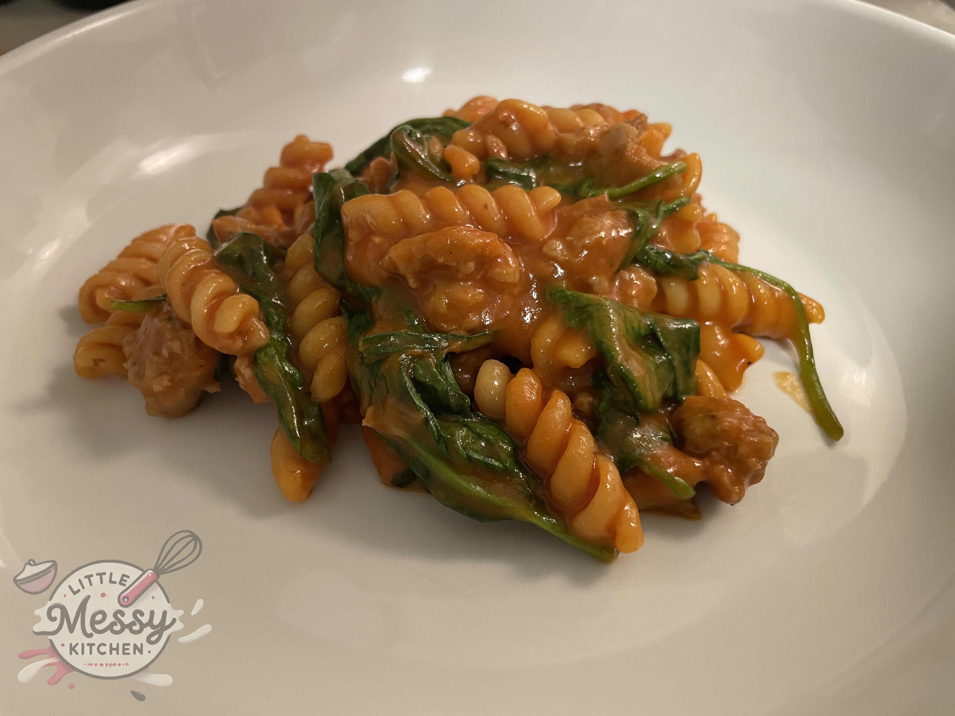 Serving of one-pot sausage pasta in a white bowl.