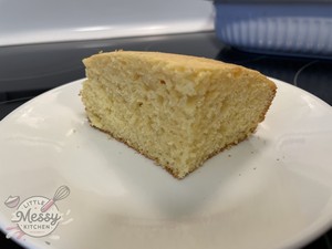 Slice of cornbread served on a white plate.