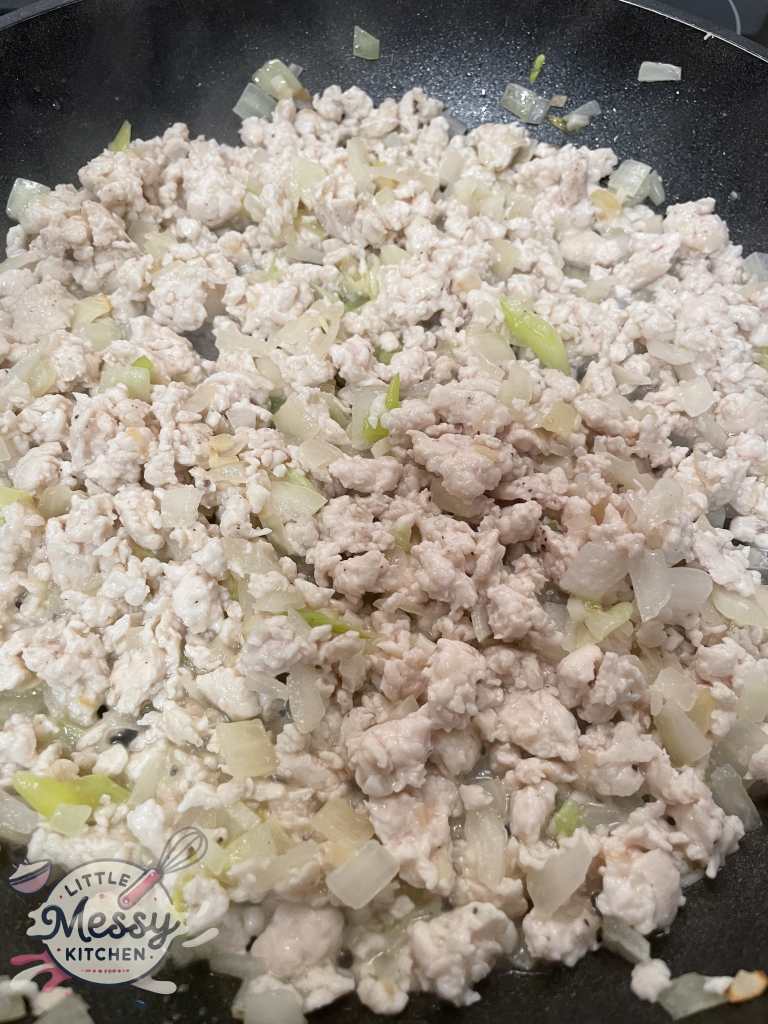 Ground chicken added to the skillet.