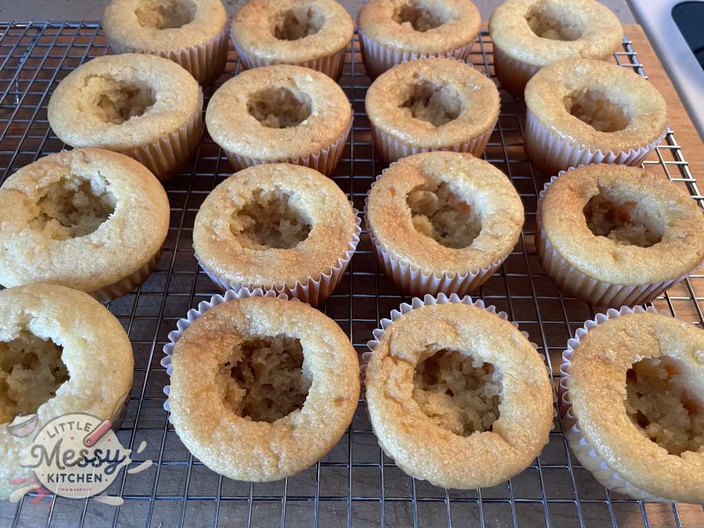 cupcakes cored on cooling rack.